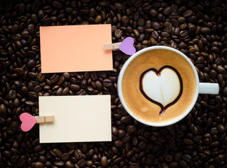 A cup of latte art coffee and clip note
