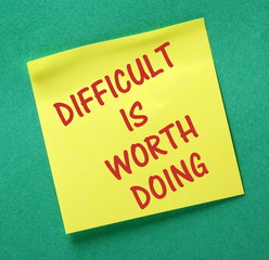Difficult Is Worth Doing on a yellow sticky note