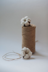 Fototapeta na wymiar Flower design with fluffy dried cotton bolls and jute rope hank 
