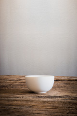 Empty little bowl on wooden tabletop