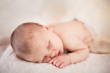 Adorable baby sleeping on stomach