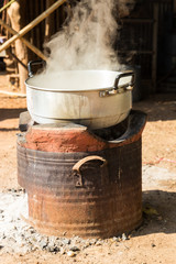 boiling water in traditional pot on charcoal stove