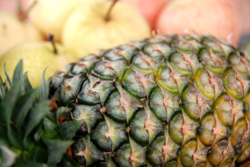 Fresh Pineapple in front of other fruit