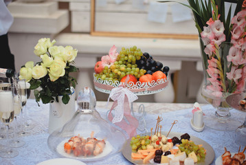 Fresh fruit in a vase on a decorated tabe with decorative elemen