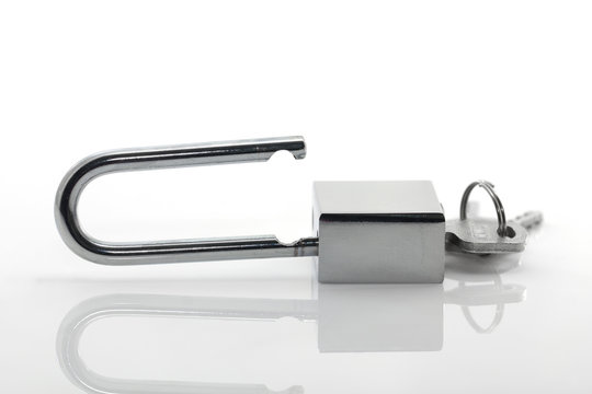 Metallic padlock with  keys on white background