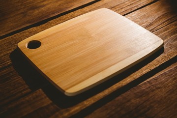 Chopping board on wooden table