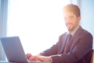 Businessman using laptop at desk