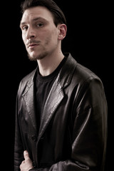Male portrait wearing leather coat and looking