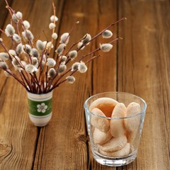 Homemade meringue in glass with bunch of pussy willow twigs in g