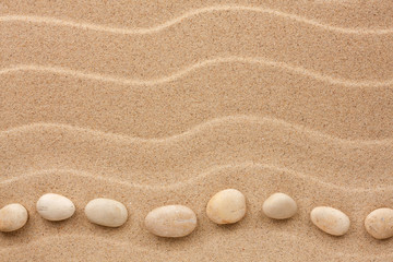 Fototapeta na wymiar White stones lie on the sand