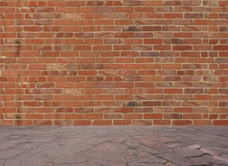 Old red brick wall with stone floor