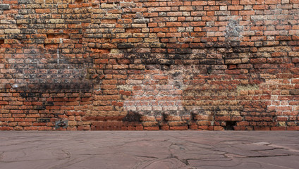Old red brick wall with stone floor