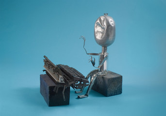 Recycled sculpture of a writer typing. © andrei_sikorskii