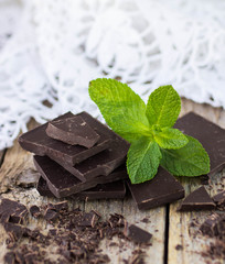 Chocolate and mint on wooden table