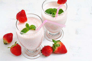 Milk shake with strawberries on white background