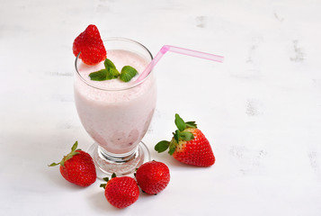 Milk shake with strawberries on white background
