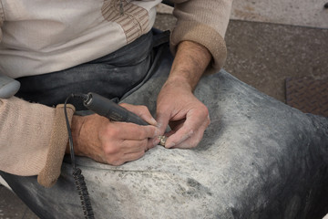 Hands of a craftsman working with an amber
