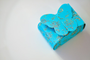 Blue gift box with sparkling butterfly