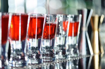 Barman makes shots in a bar