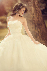 Beautiful brunette bride with stylish make-up in white dress