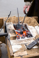 old blacksmith forge with hot coals