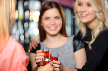 Three women have a drink in the bar