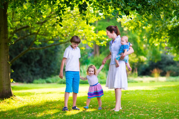 Fototapeta premium Mother and children in a park