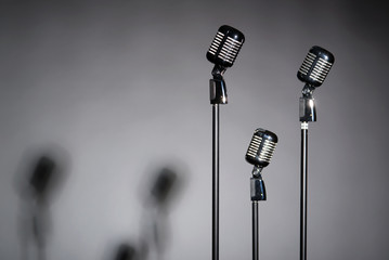 Three old fashioned microphones with space for text