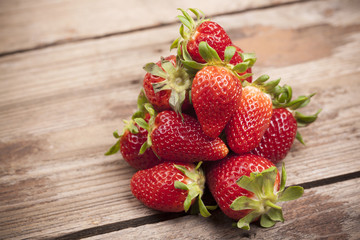 Ripe strawberries on wooden background