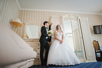 Young beautiful wedding couple at the hotel room
