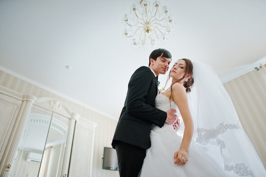 Young Beautiful Wedding Couple At The Hotel Room