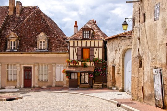 Quaint street in a town in Burgundy, France with timbered house
