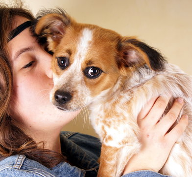 Studio Shot Of A Young Lady Holding A Little Dog