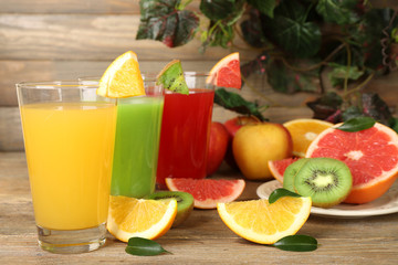 Fresh juices with fruits on wooden table