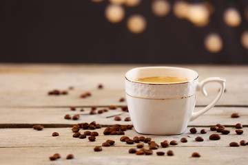Cup of coffee on table on brown background