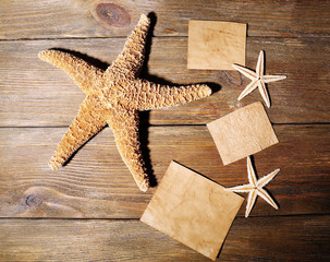 Card blanks with sea stars on wooden background