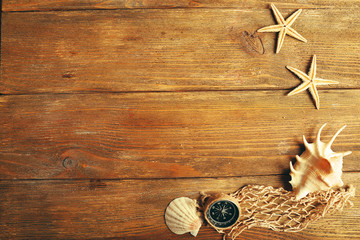 Sea stars and shells on wooden background