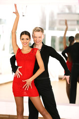 Fototapeta premium Beautiful couple in active ballroom dance, indoors