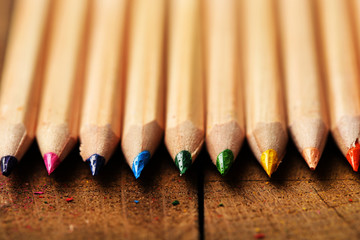 Wooden colorful pencils on wooden table