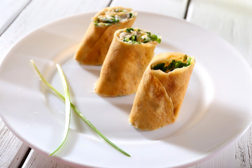 Pancakes with cream, cheese and greens in plate