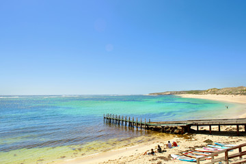 Pier in blue water of the ocean shore