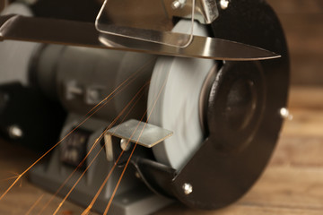 Knife sharpener on wooden table, closeup