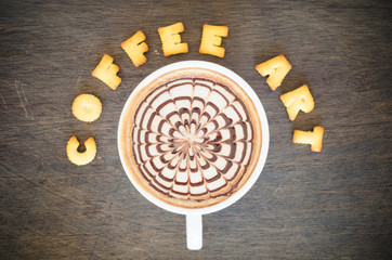 A cup of latte art and alphabet 