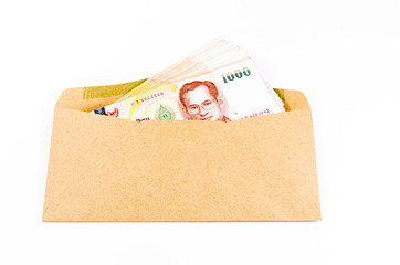 Stack of thai banknote on brown develope  isolated on white back