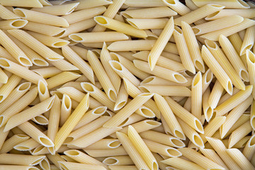 Background texture of penne, rigate or ziti pasta