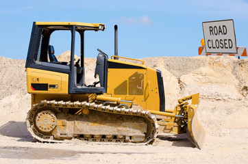 Tractor bulldozer working on road construction © Michael O'Keene