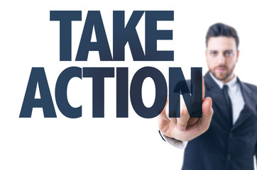 Business man pointing the text: Take Action