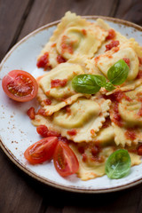 Close-up of square ravioli with tomato sauce, selective focus