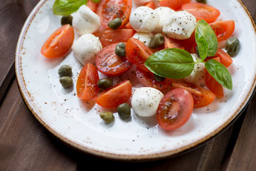 Close-up of caprese salad with capers, selective focus