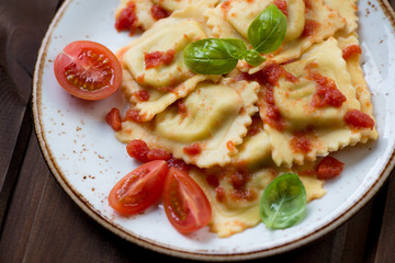 Ravioli with tomato sauce and basil, close-up, selective focus
